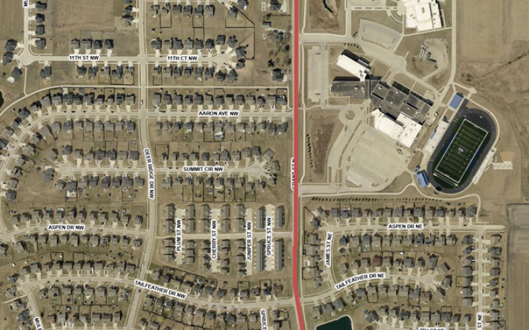 Aerial map of a residential neighborhood with a red line marking a house-moving route.